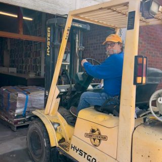 Johnny Bart Hudson helps move books